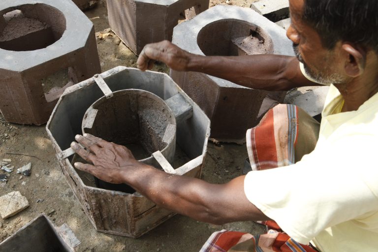 Hands form an improved cookstove.