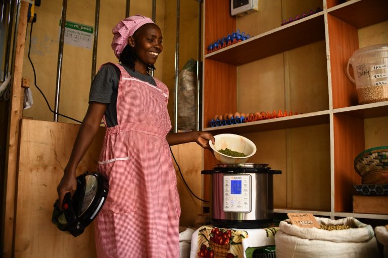 A women is putting cereals in an electric pressure cooker.