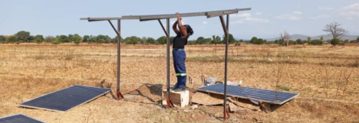 Young woman installing a solar panel.