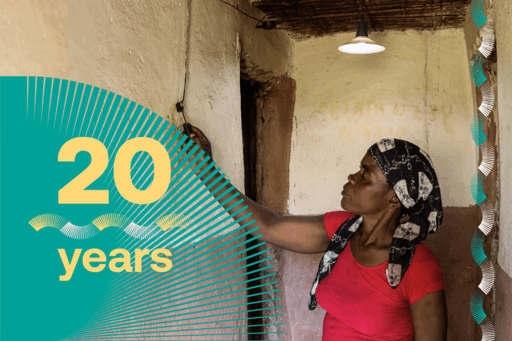 A women is switching a solar-powered light inside her home.