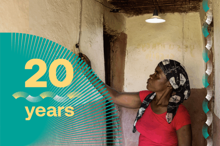 A women is switching a solar-powered light inside her home.